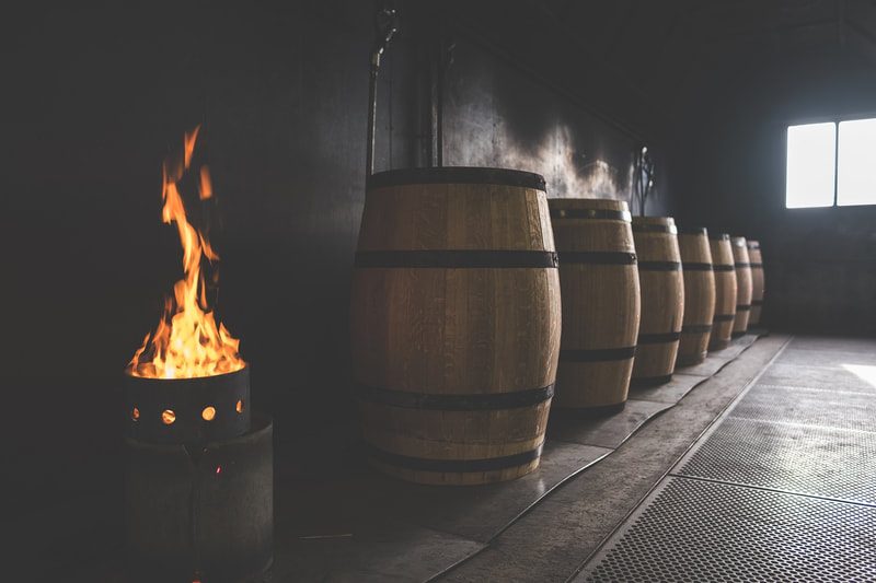 Toasting barrels over fire at the D&J cooperage